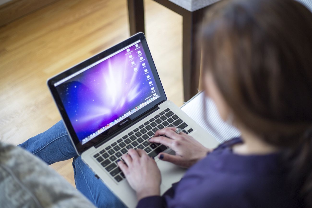 Free woman typing on laptop