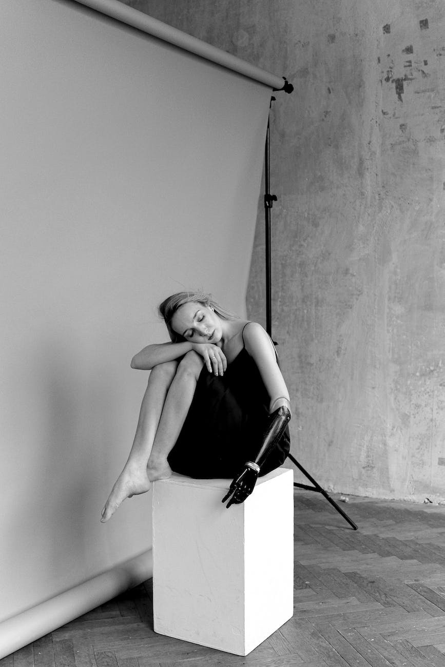 woman in slip dress sitting on object